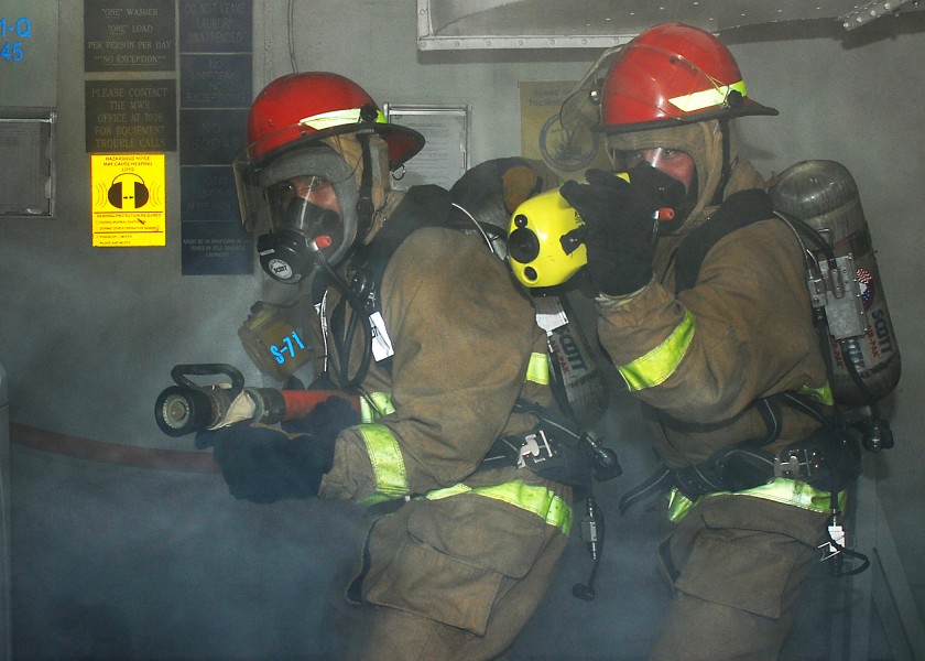 US Navy 110721-N-VA590-216 Repair locker personnel respond to a simulated fire during a general quarters drill aboard the aircraft carrier USS Abra