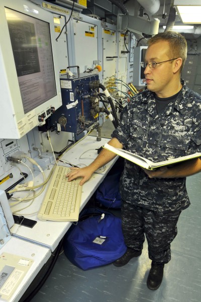 US Navy 110722-N-EE987-045 Aviation Electronics Technician 2nd Class Matt Mitton, from Helena, Mont., uses a consolidated automated support system 