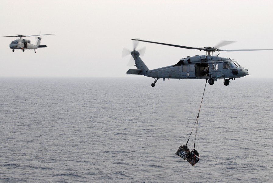 US Navy 110722-N-KF029-017 MH-60S Sea Hawk helicopters assigned to the Wild Cards of Helicopter Sea Combat Squadron (HSC) 23 transfer pallets of su
