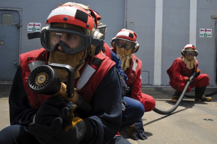 US Navy 110810-N-YM590-035 Navy Sailors man an aqueous film forming foam hose during a flight deck fire drill aboard the guided-missile cruiser USS
