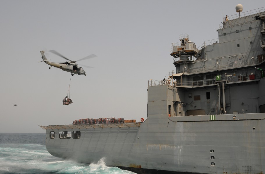 US Navy 110812-N-XQ375-446 An SH-60 Sea Hawk helicopter transfers pallets of stores from the Military Sealift Command dry cargo and ammunition ship