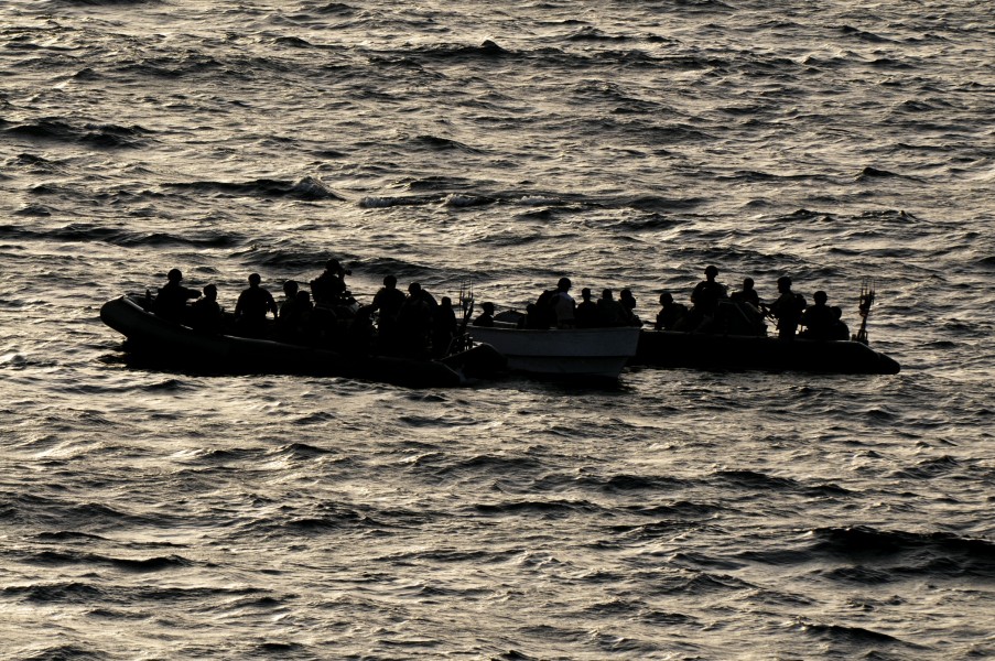 US Navy 110812-N-YM590-482 Members of a visit, board, search and seizure team from the guided-missile cruiser USS Anzio (CG 68) assist mariners abo