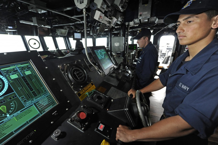US Navy 110916-N-VH839-080 eaman Art Casillas, a helmsman aboard the Arleigh Burke-class guided-missile destroyer USS Dewey (DDG 105), steers the s