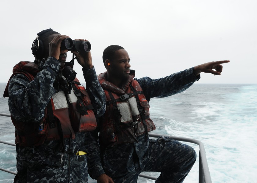 US Navy 110926-N-VR587-083 Boatswain's Mate Seaman James Webb and Seaman Hakeem Black stand watch aboard USS Abraham Lincoln (CVN 72)