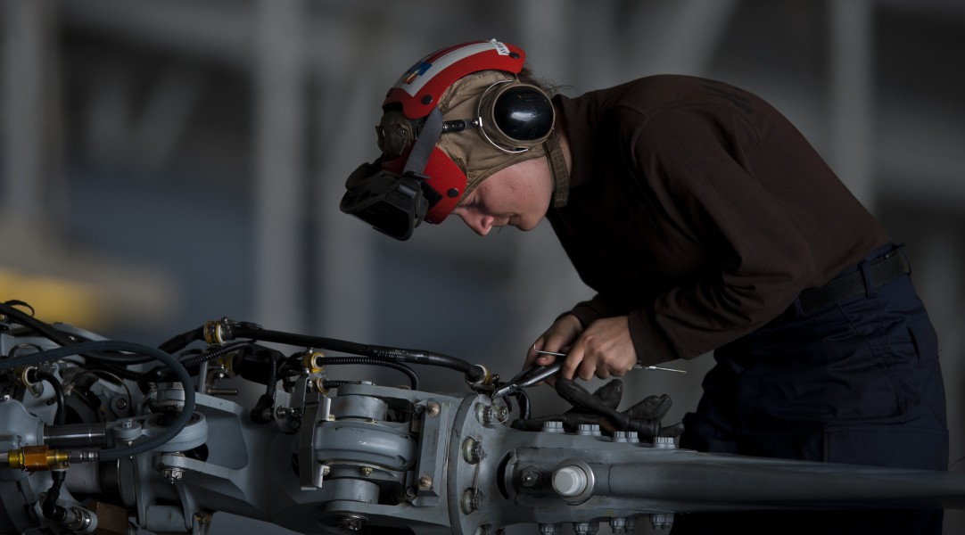 US Navy 111005-N-TU221-052 Airman Christyl Roper performs maintenance on the propellers of an MH-60R Sea Hawk helicopter in the hangar bay