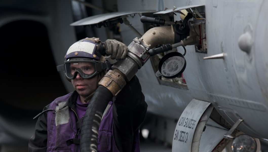 US Navy 111005-N-TU221-487 A Sailor refuels an F-A-18C Hornet assigned to the Vigilantes of Strike Fighter Squadron (VFA) 151