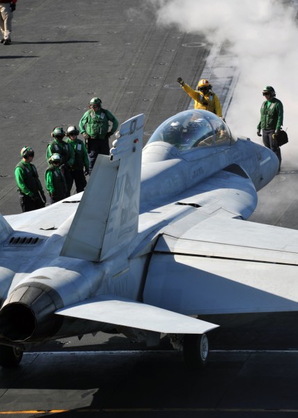 US Navy 111006-N-YB753-074 An aviation boatswain's mate (handling) directs an F-A-18F Super Hornet assigned to the Bounty Hunters of Strike Fighter