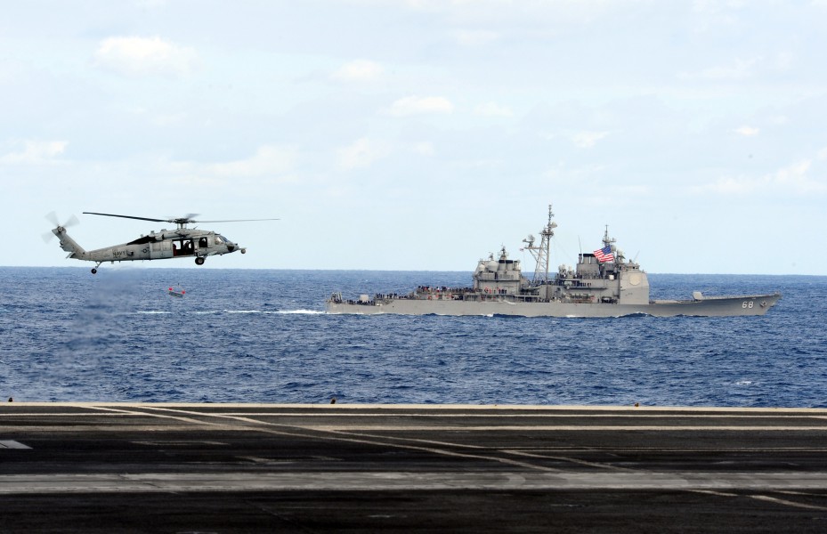 US Navy 111209-N-QL471-353 Helicopter performs a fly-by