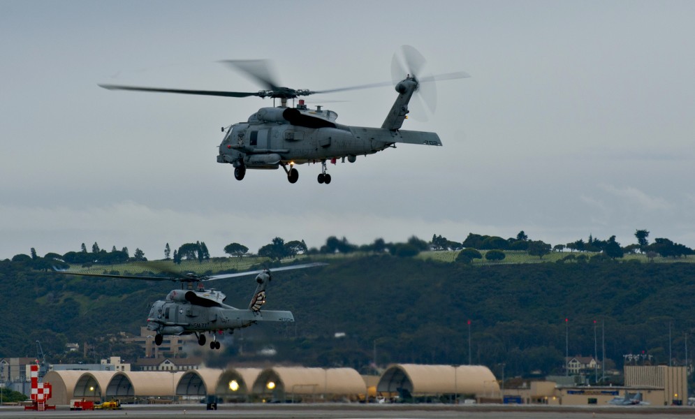US Navy 111213-N-HW704-001 Two MH60R Sea Hawk helicopters assigned to the Saberhawks of Helicopter Maritime Strike Squadron (HSM) 77 take off from 