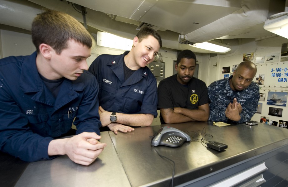 US Navy 111219-N-VO377-014 Sailors talk to New Orleans Saints tight-end Jimmy Graham during a holiday morale phone call aboard the Nimitz-Class air