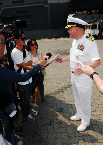 US Navy 120106-N-SK590-049 Capt. John D. Alexander, commanding officer of the Nimitz-class aircraft carrier USS Abraham Lincoln (CVN 72), speaks wi