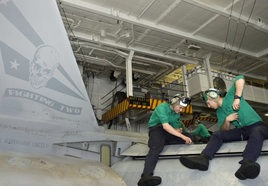 US Navy 120111-N-VO377-010 Sailors perform maintenance on an F-A-18F Super Hornet