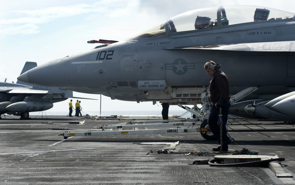 US Navy 120112-N-JN664-113 Aviation Structural Mechanic Airman Apprentice Jordan Ortiz secures an F-A-18F Super Hornet to the flight deck of the Ni
