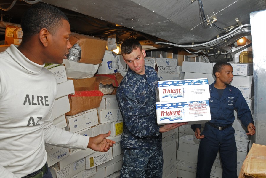 US Navy 120121-N-NB694-110 Sailors assigned to the Nimitz-class aircraft carrier USS Abraham Lincoln (CVN 72) put away supplies during a replenishm