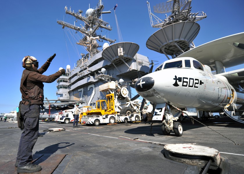 US Navy 120206-N-YB753-046 Aviation Structural Mechanic Airman Gregory Hardway relays pre-flight signals between pilots and maintainers on the flig