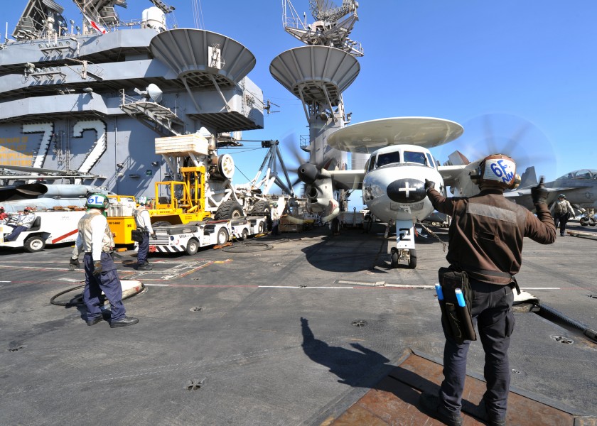 US Navy 120206-N-YB753-052 Aviation Structural Mechanic Airman Gregory Hardway relays pre-flight signals between pilots and maintainers on the flig