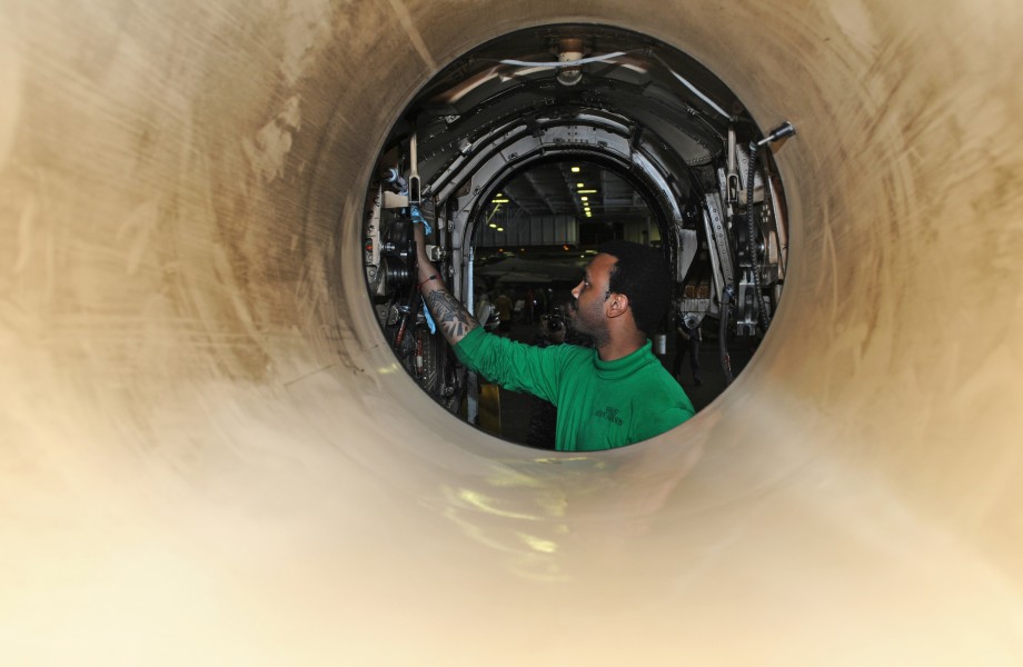 US Navy 120207-N-KQ416-155 A Sailor performs corrosion prevention maintenance on the inside of a jet
