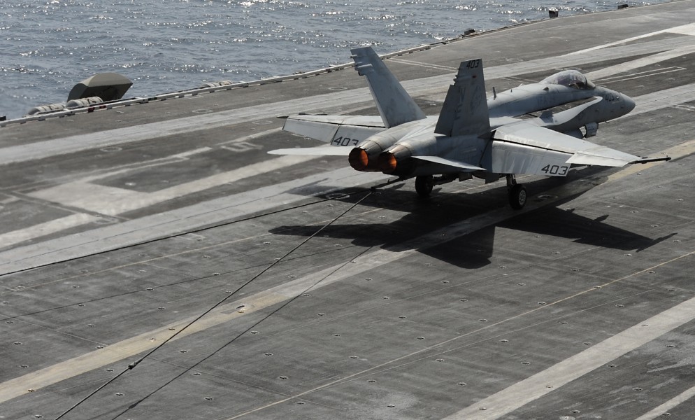 US Navy 120216-N-VO377-432 An F-A-18C Hornet assigned to the Blue Blasters of Strike Fighter Squadron (VFA) 34 traps the arresting wire on the flig
