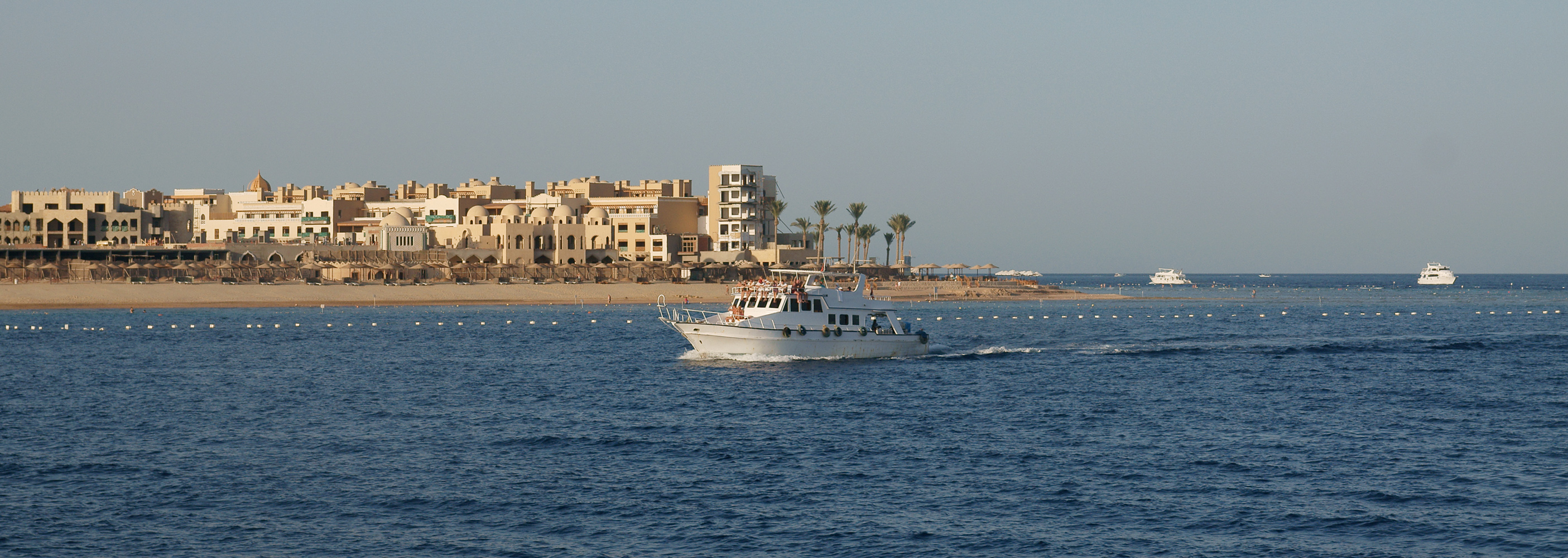 Tip of Makadi Bay with cruising boat