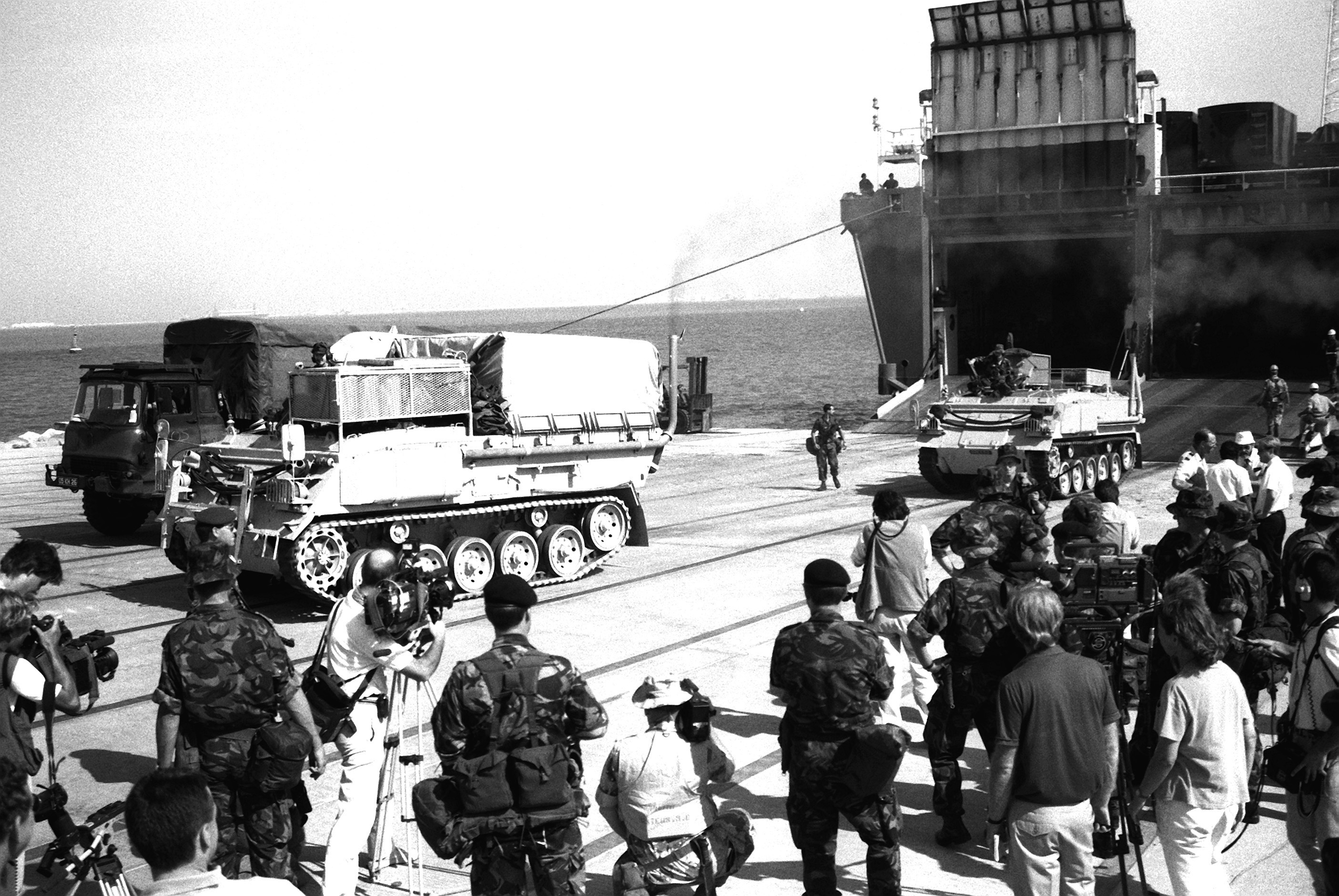 Two British FV432 armored vehicles leave the Danish cargo ship Dana Cimbria during Operation Desert Shield