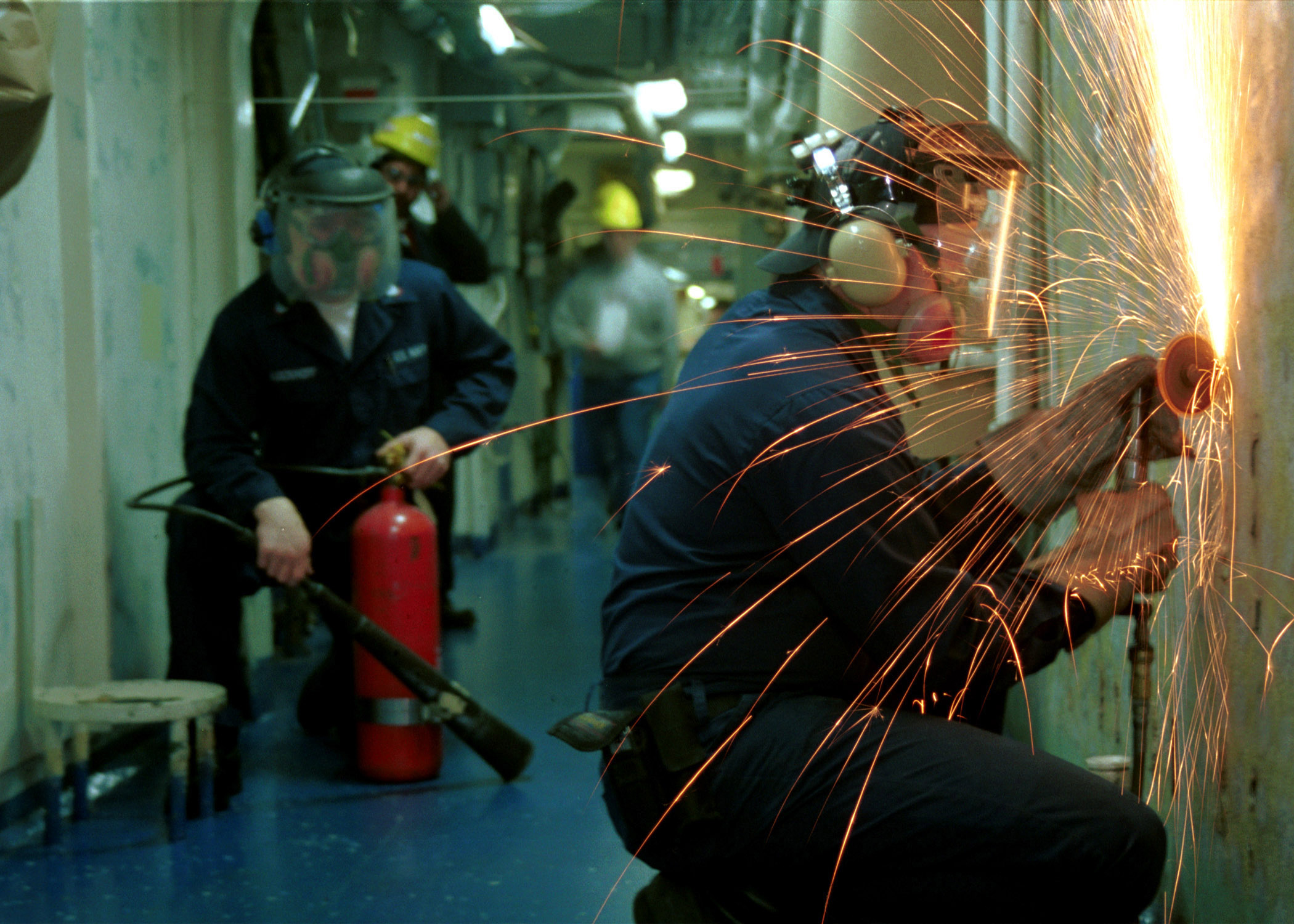 US Navy 020412-N-9421C-001 Sailor grinds 