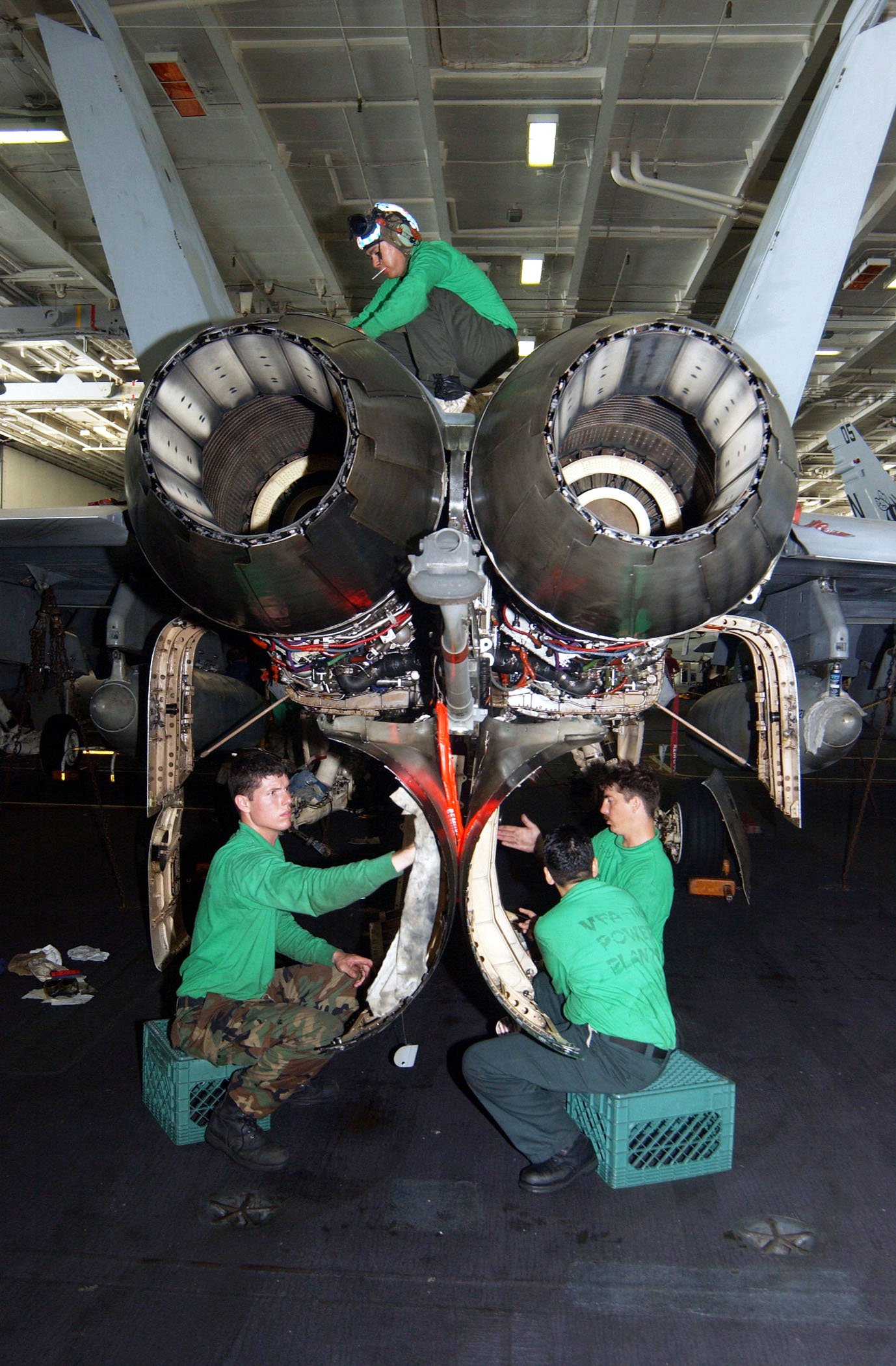 US Navy 020928-N-6817C-001 Super Hornet receives maintenance in hangar bay aboard CVN 72