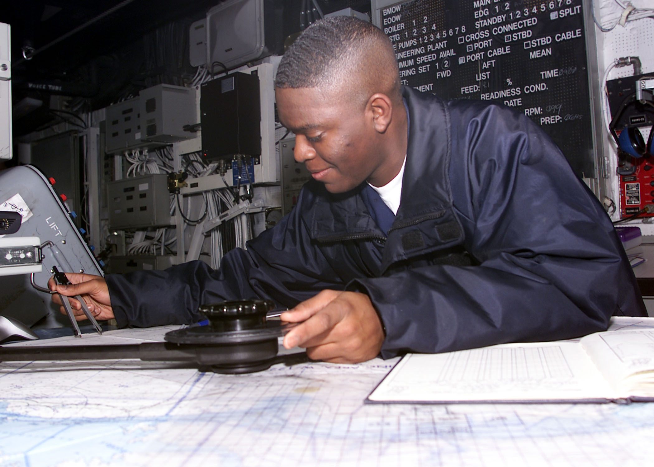 US Navy 030115-N-9109V-001 Quartermaster 3rd Class Richard Jones from Alexandria, La., plots a course 