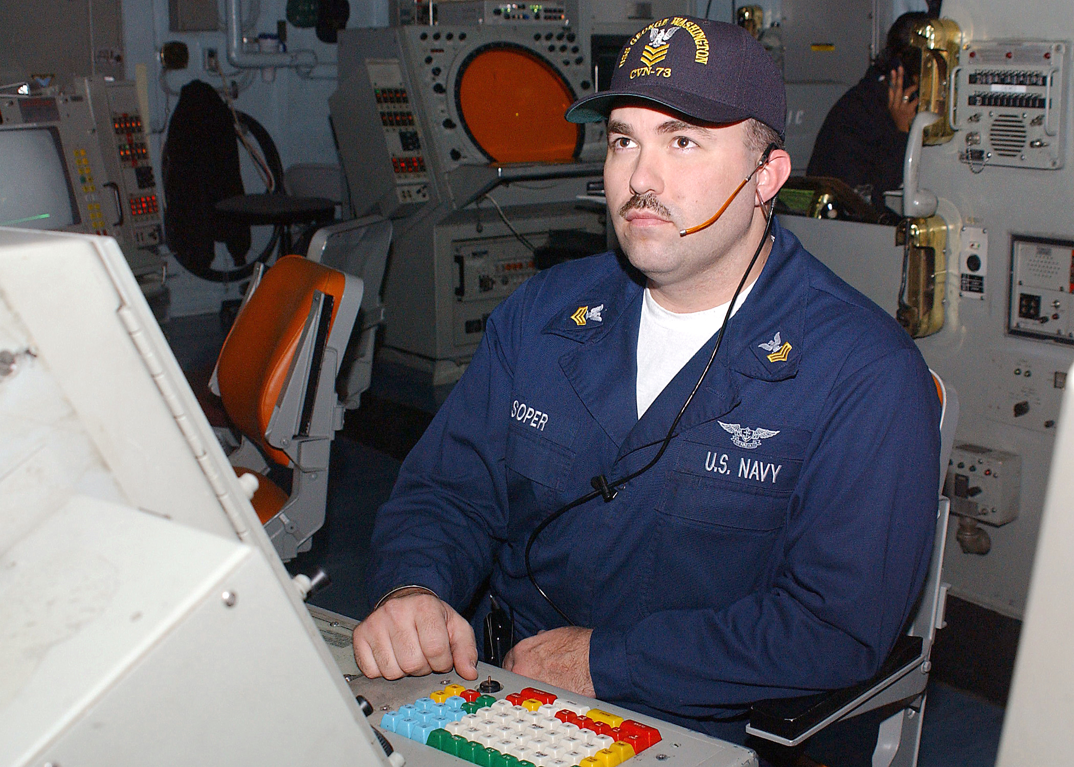US Navy 030127-N-6653S-001 Air Traffic Controller 1st Class Brian Soper keeps track of incoming and outgoing aircraft on his radar console