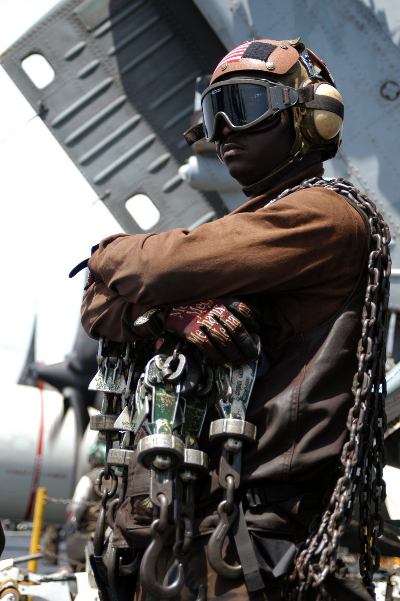 US Navy 030404-N-1159M-038 A Plane Captain stands by with tie down chains during an aircraft^rsquo,s recovery (landing) aboard USS Abraham Lincoln (CVN 72)