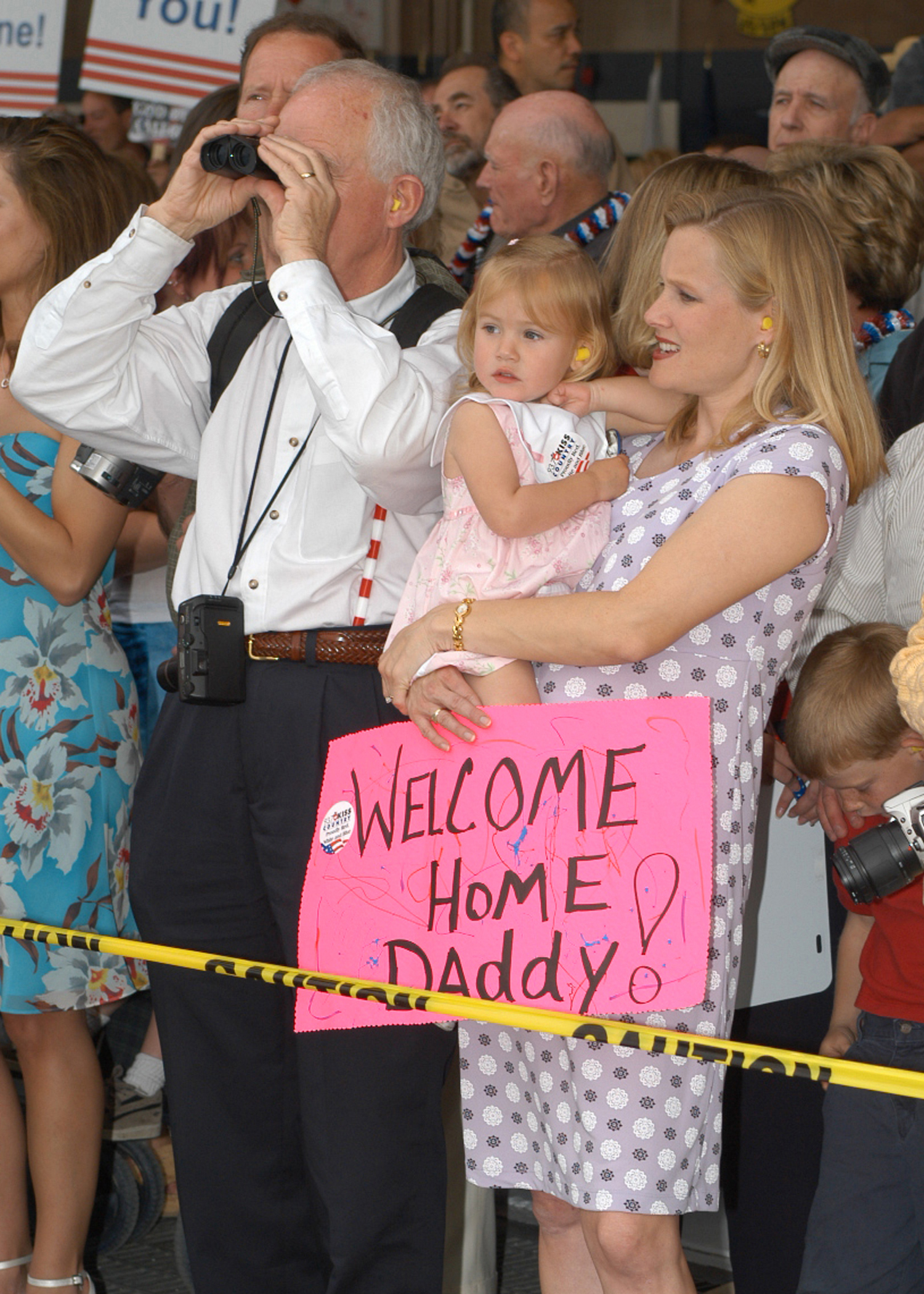 US Navy 030501-N-7032B-001 Family and friends eagerly await to welcome home sailors during the homecoming of Carrier Air Wing Fourteen (CVW-14) at Naval Air Station (NAS) Lemoore