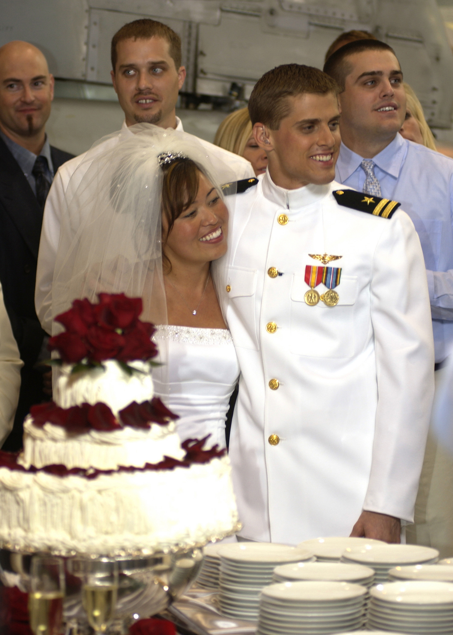 US Navy 030501-N-8590B-003 Lieutenant David Kozminski, a Naval Aviator assigned to Sea Control Squadron Thirty Five (VS-35) and his bride prepare to cut their wedding cake