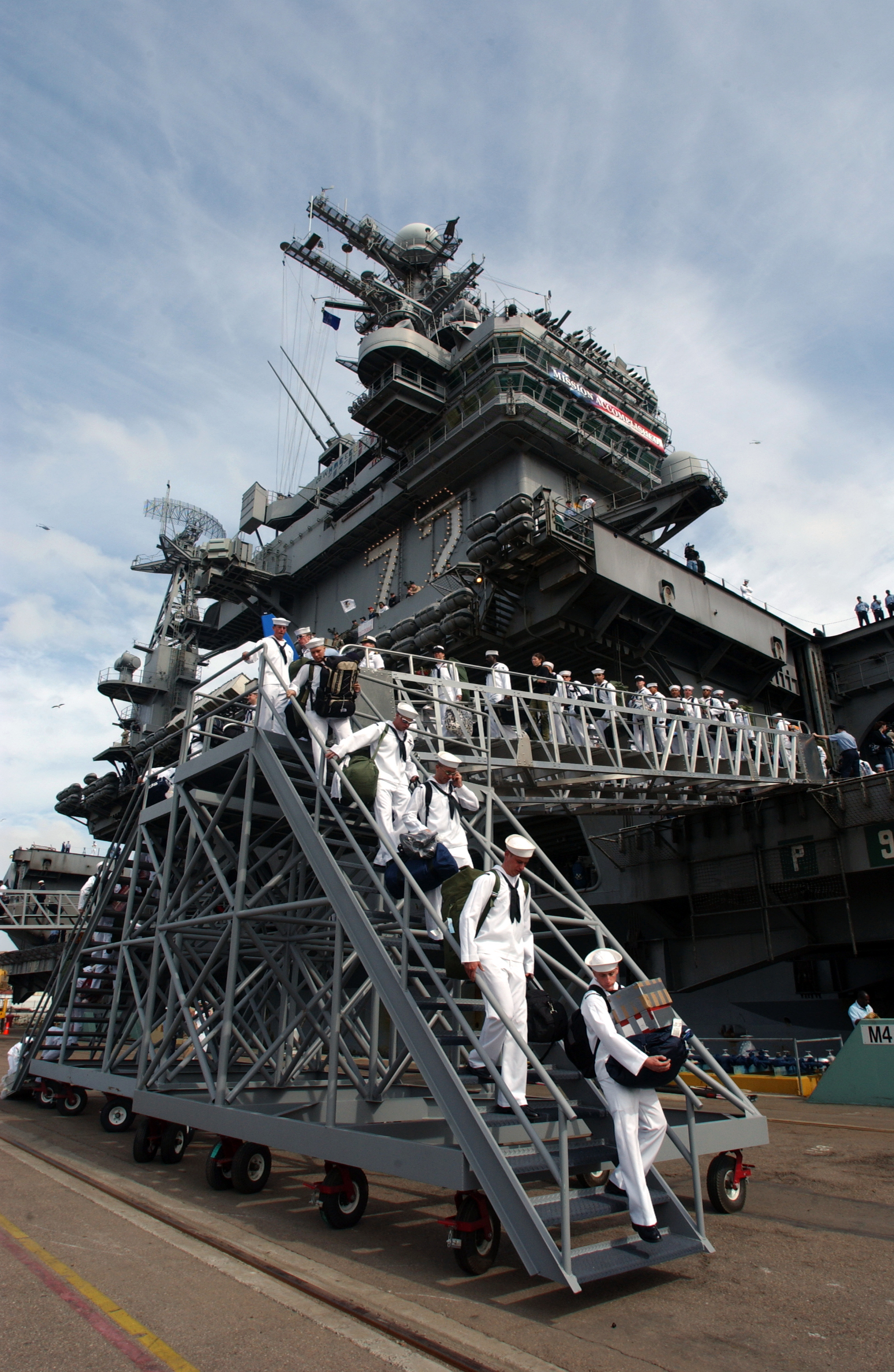US Navy 030502-N-3236B-008 Sailors assigned to USS Abraham Lincoln (CVN 72) disembark upon the ship^rsquo,s arrival at NAS North Island