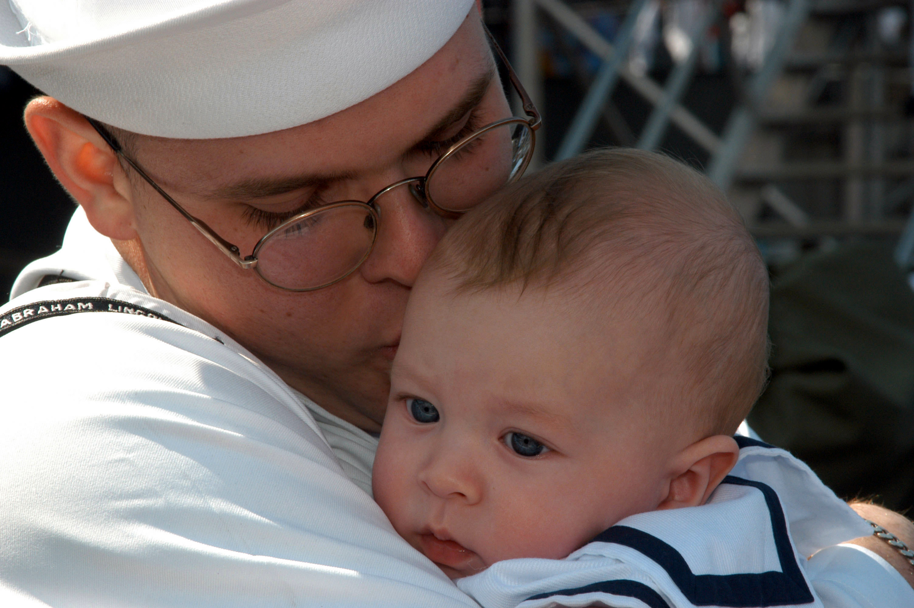 US Navy 030506-N-1002W-003 A sailor aboard USS Abraham Lincoln (CVN 72) embraces his son for the first time