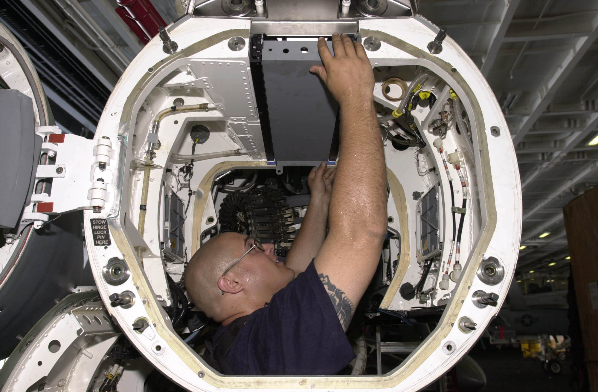 US Navy 030616-N-2143T-004 Aviation Electronics Technician 2nd Class James Gray from Bakersfield, Calif., works on an installation rack