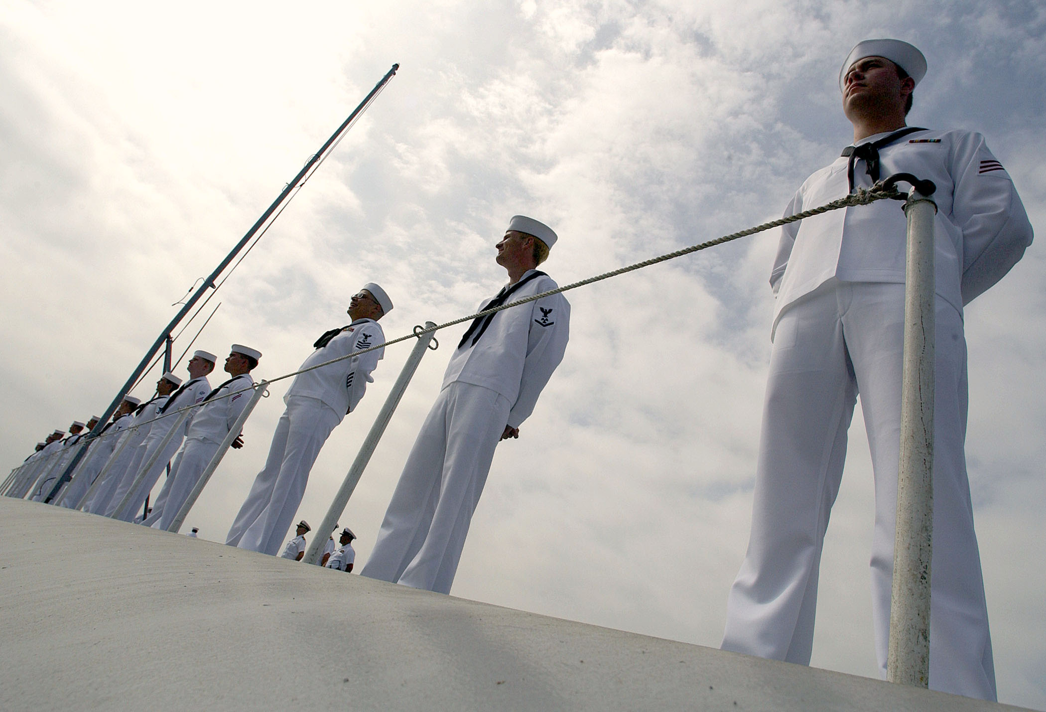 US Navy 031004-N-9769P-116 Sailors man the rails of USS John C. Stennis (CVN 74) as the ship arrives in port during the annual San Diego Fleet Week parade of ships ceremony