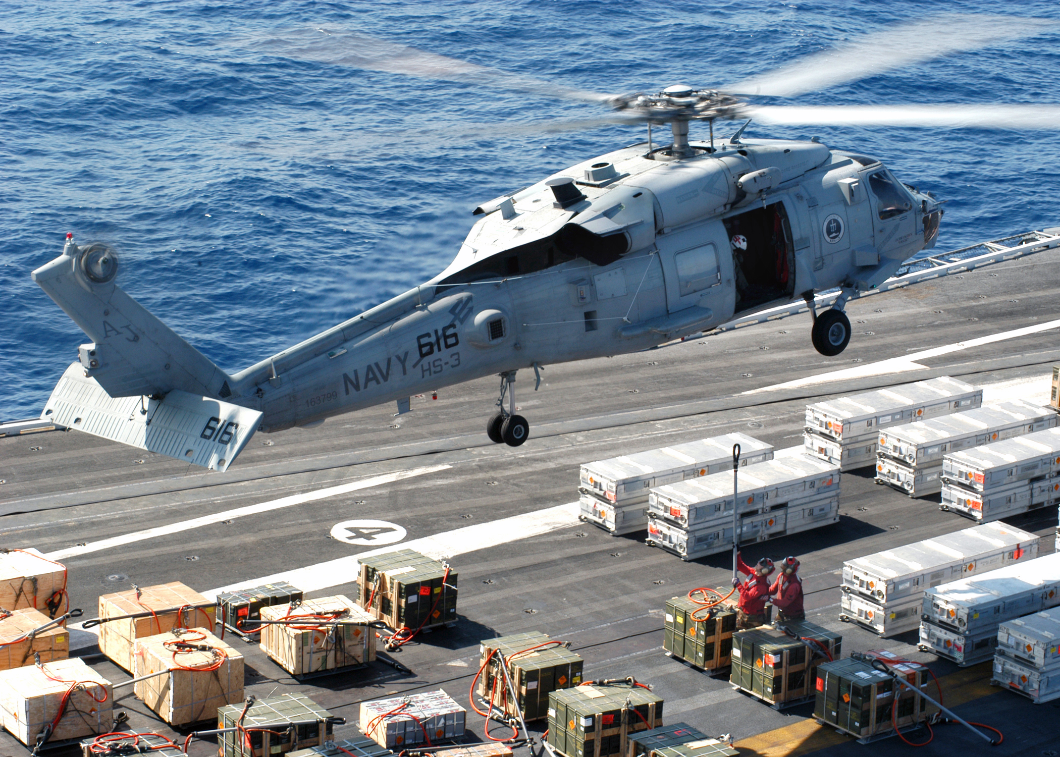 US Navy 040423-N-7408M-004 An SH-60F Seahawk hovers just above the flight deck of USS Enterprise (CVN 65)