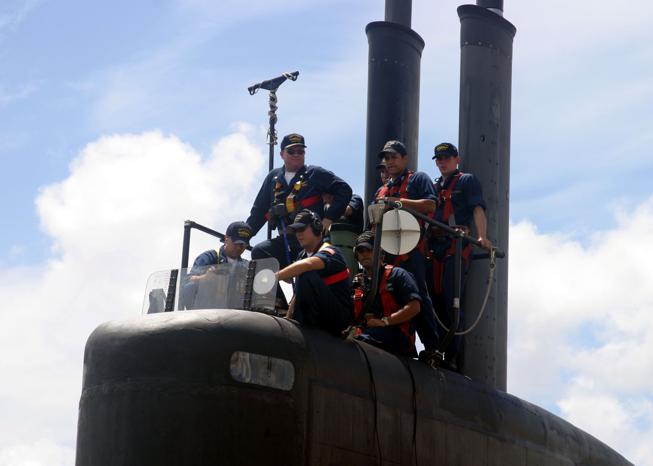 US Navy 040520-N-5539C-001 Commanding Officer Cmdr. James Pitts, center, USS Tucson (SSN 770), and members of this navigation detail man the boat's sail