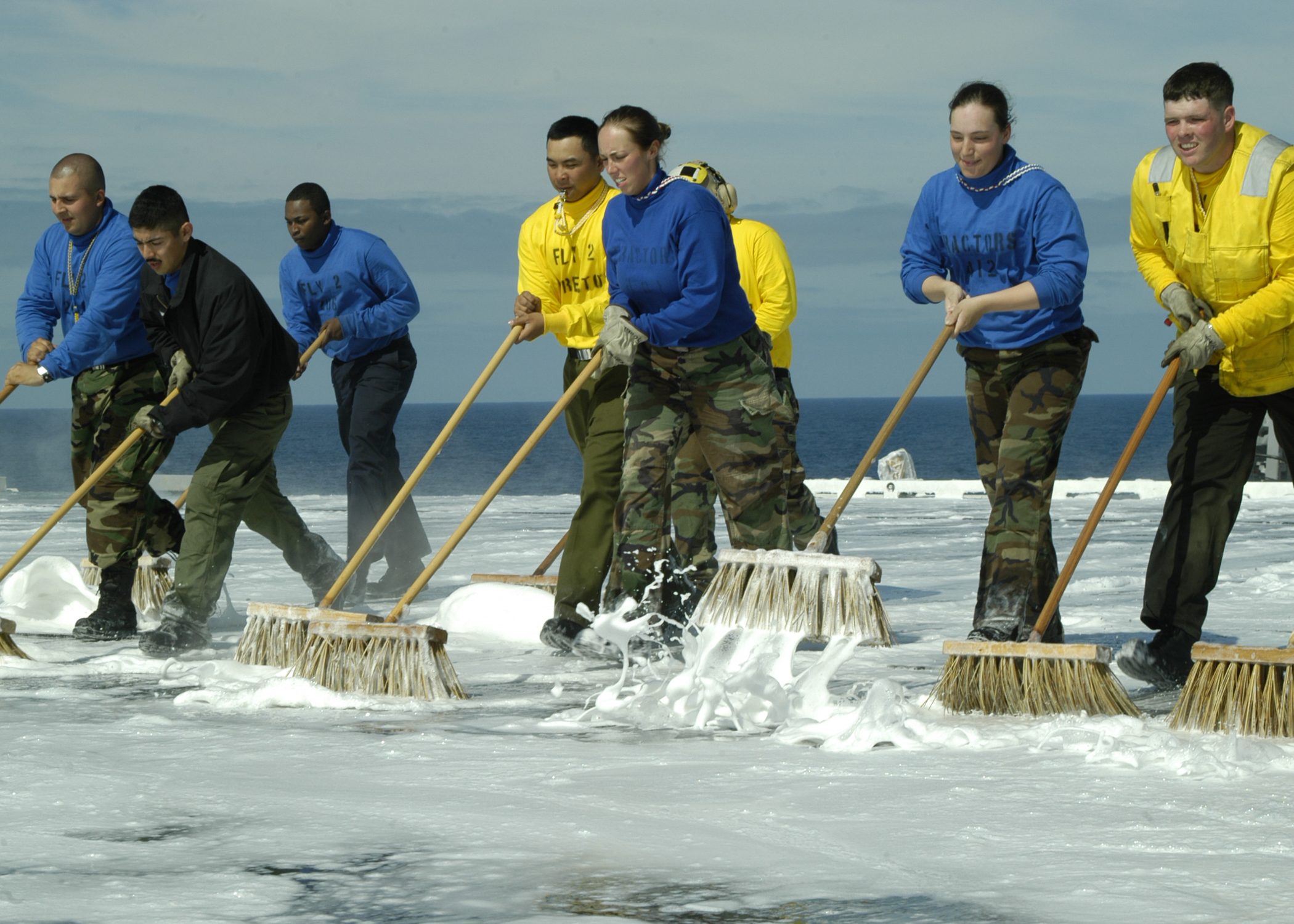 US Navy 040603-N-8497H-034 USS Abraham Lincoln (CVN 72) Sailors from Air Department^rsquo,s V-1 and V-3 divisions, scrub down the flight deck after a counter-measure wash down test