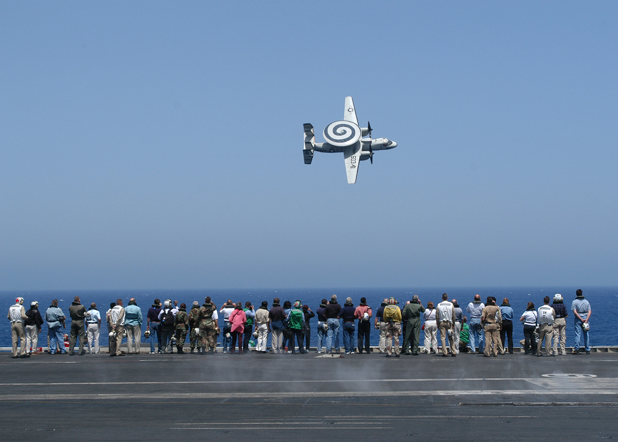 US Navy 040611-N-9742R-100 Members of the 67th Joint Civilian Orientation Conference (JCOC) observe the fly-by of an E-2C Hawkeye