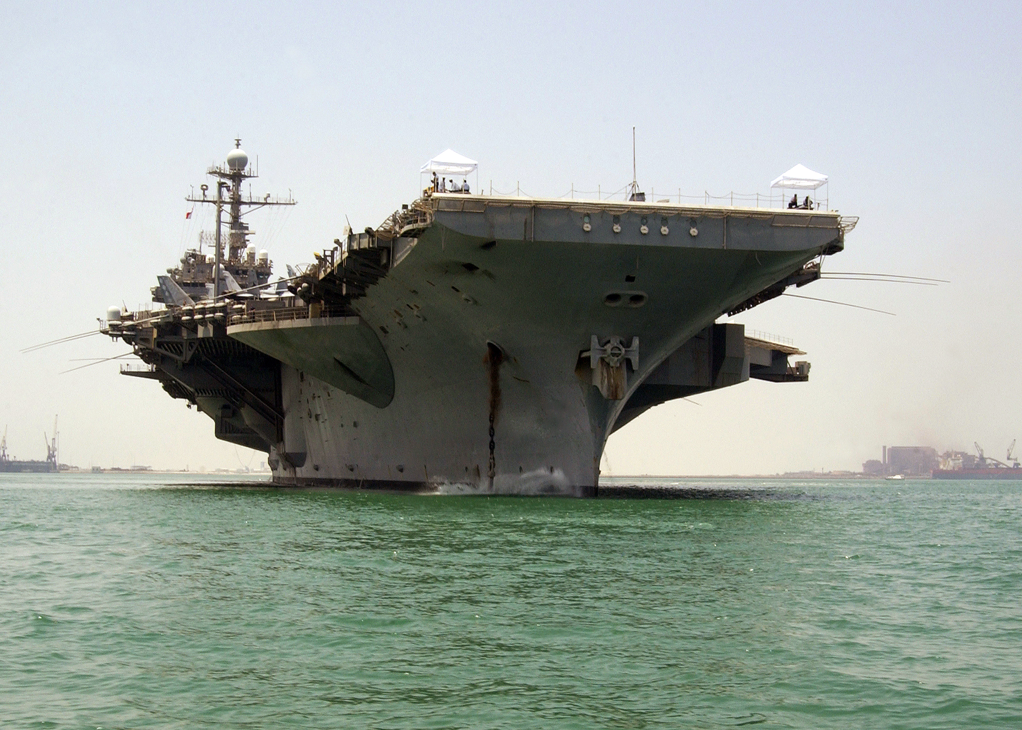 US Navy 040802-N-7034S-001 The conventional powered aircraft carrier USS John F. Kennedy (CV 67) drops anchor off the coast of Manama, Bahrain for a port visit