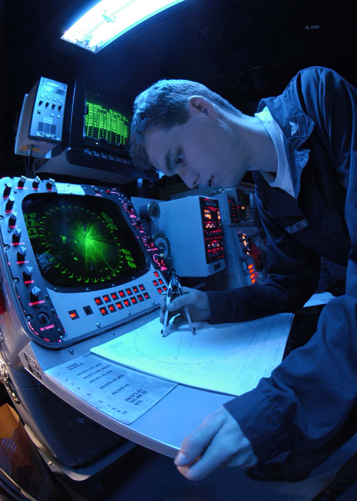 US Navy 041026-N-5362F-016 Operations Specialist 3rd class Jon Morgantini of Santa Barbra, Calif., uses the SPA-25 surface radar aboard USS Abraham Lincoln (CVN 72) to plot surface contacts