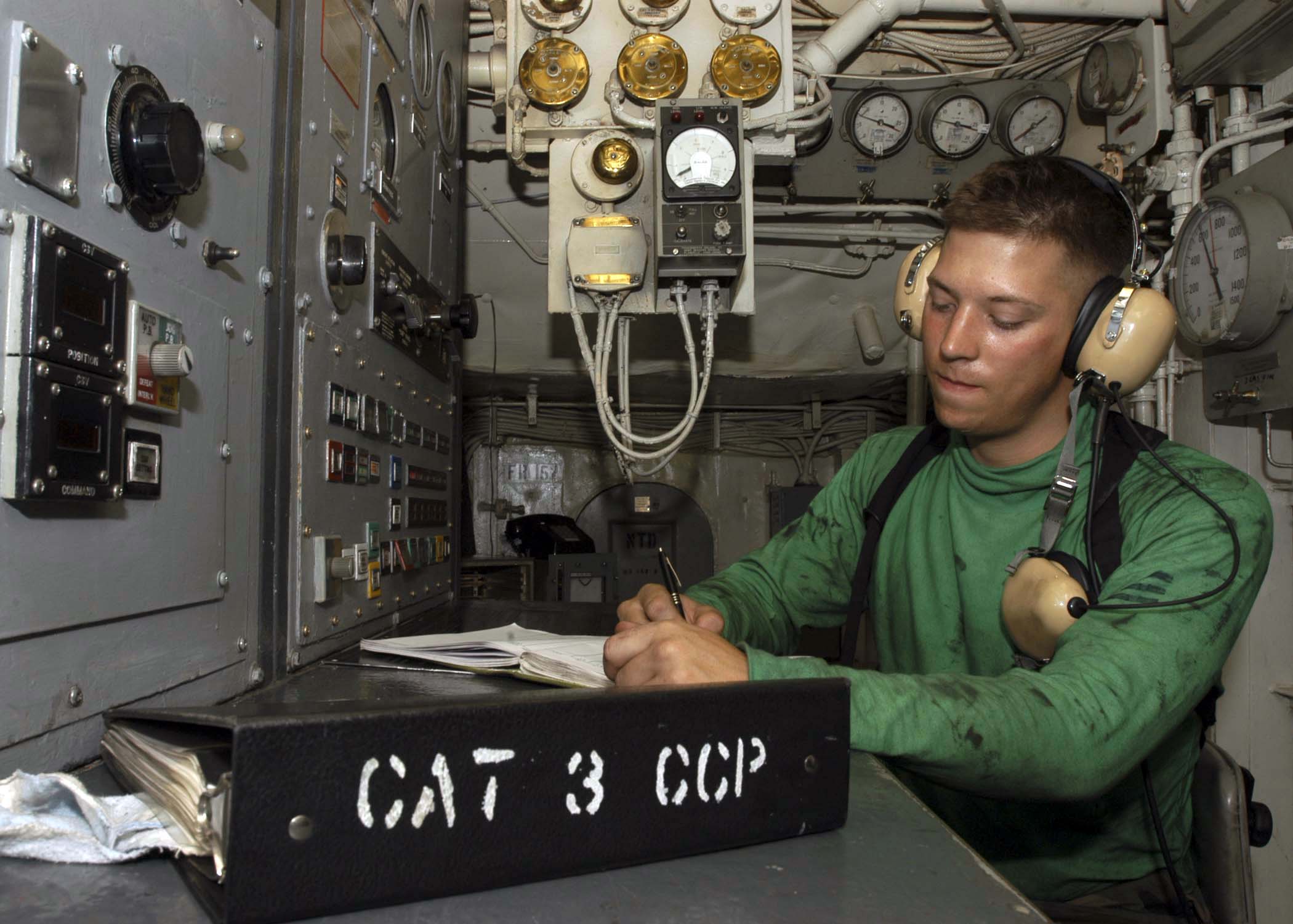 US Navy 041117-N-9079D-073 Airman Matt Rommel logs catapult shot numbers for Catapult Three in the Rotary Room aboard the Nimitz-class aircraft carrier USS Abraham Lincoln (CVN 72)
