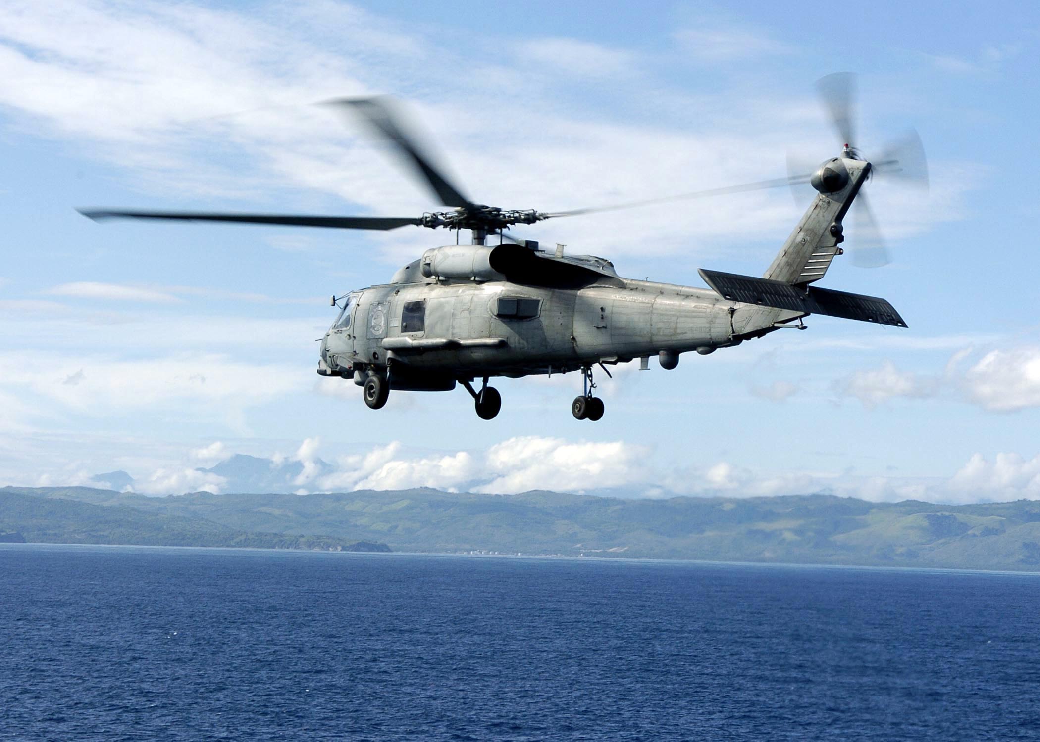 US Navy 050111-N-6817C-051 An SH-60B Seahawk takes off from the flight deck aboard USS Abraham Lincoln (CVN 72) toward the island of Sumatra, Indonesia