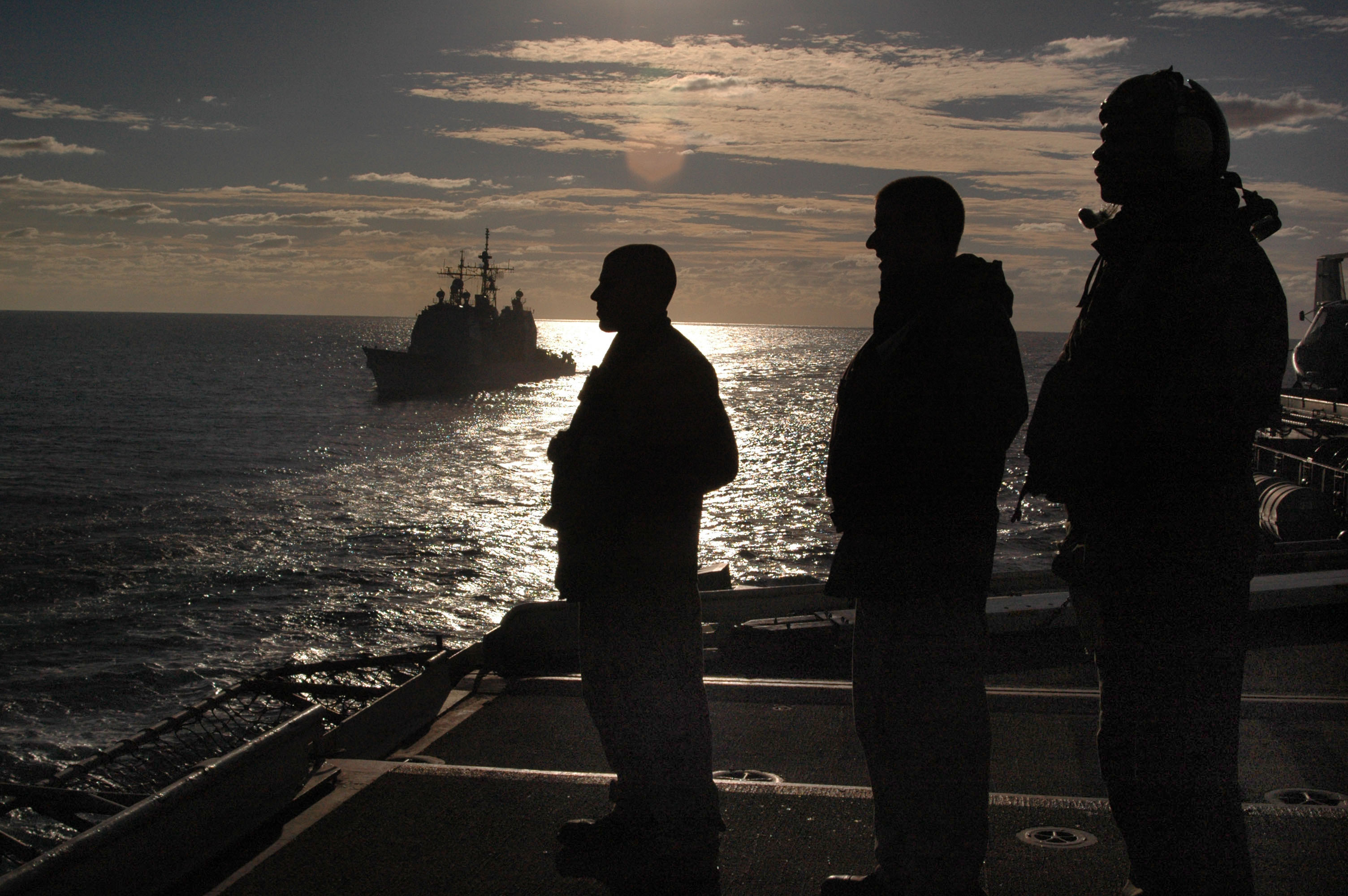 US Navy 050617-N-9551Z-079 Sailors observe a replenishment at sea from the flight deck aboard the conventionally powered aircraft carrier USS Kitty Hawk (CV 63)
