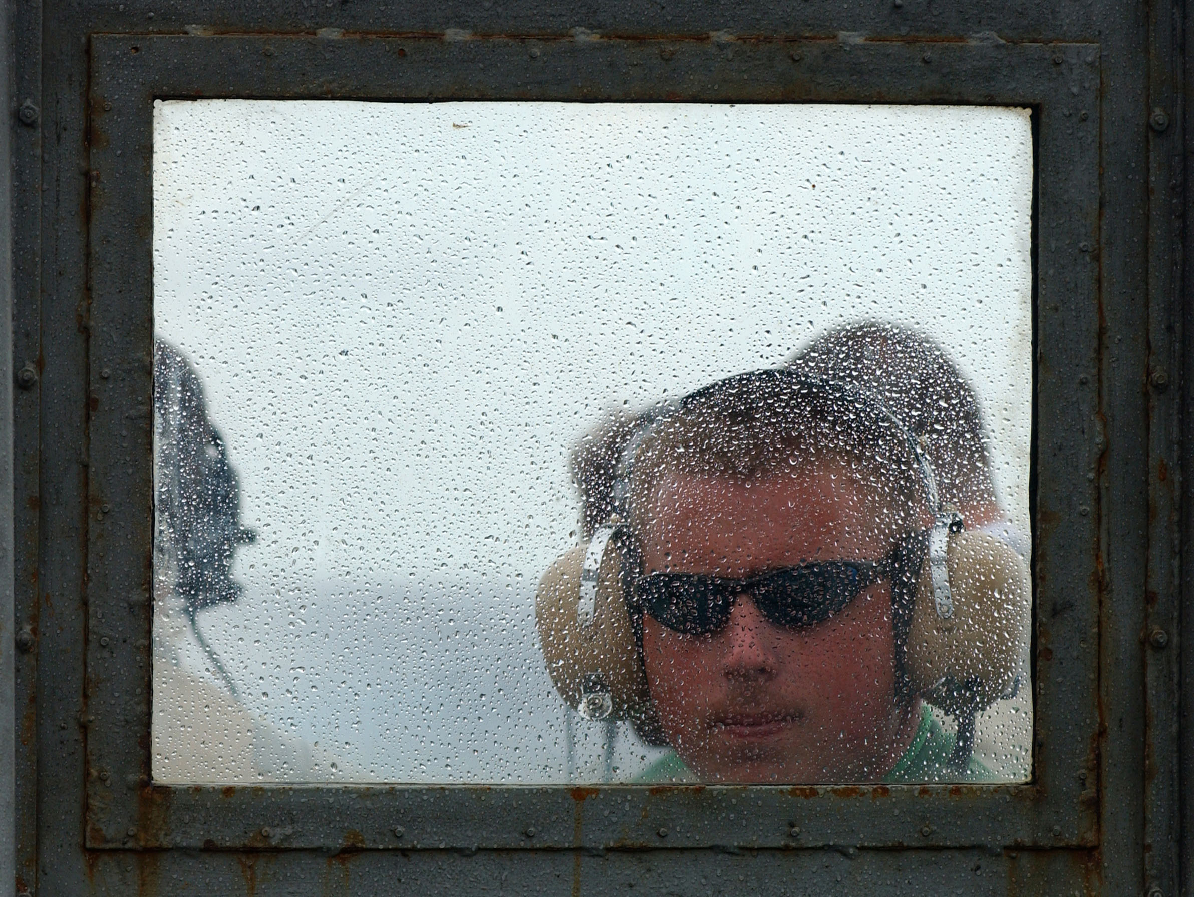US Navy 050718-N-5345W-055 A Sailor assigned to the Air Department looks through the rain-spattered windshield glass on the Landing Signal Officer (LSO) platform during flight operations