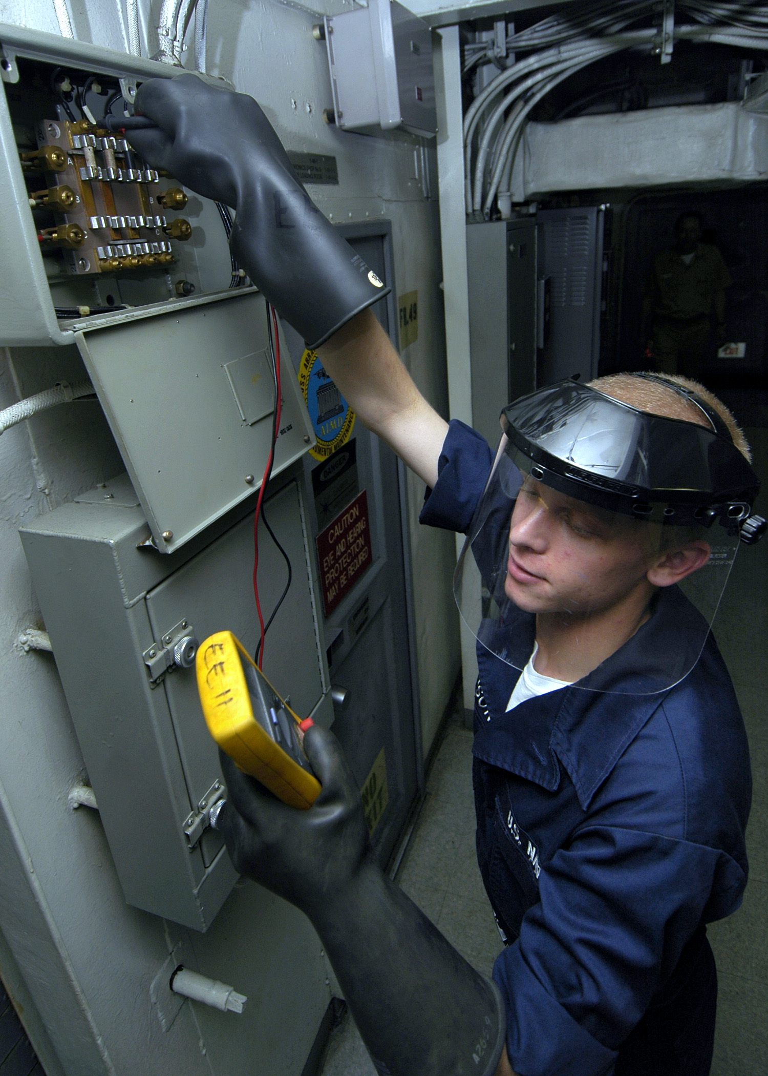 US Navy 060504-N-1745W-156 Electricians Mate Fireman Drew changes a fuse in a distribution box aboard the Nimitz-class aircraft carrier USS Abraham Lincoln (CVN 72)