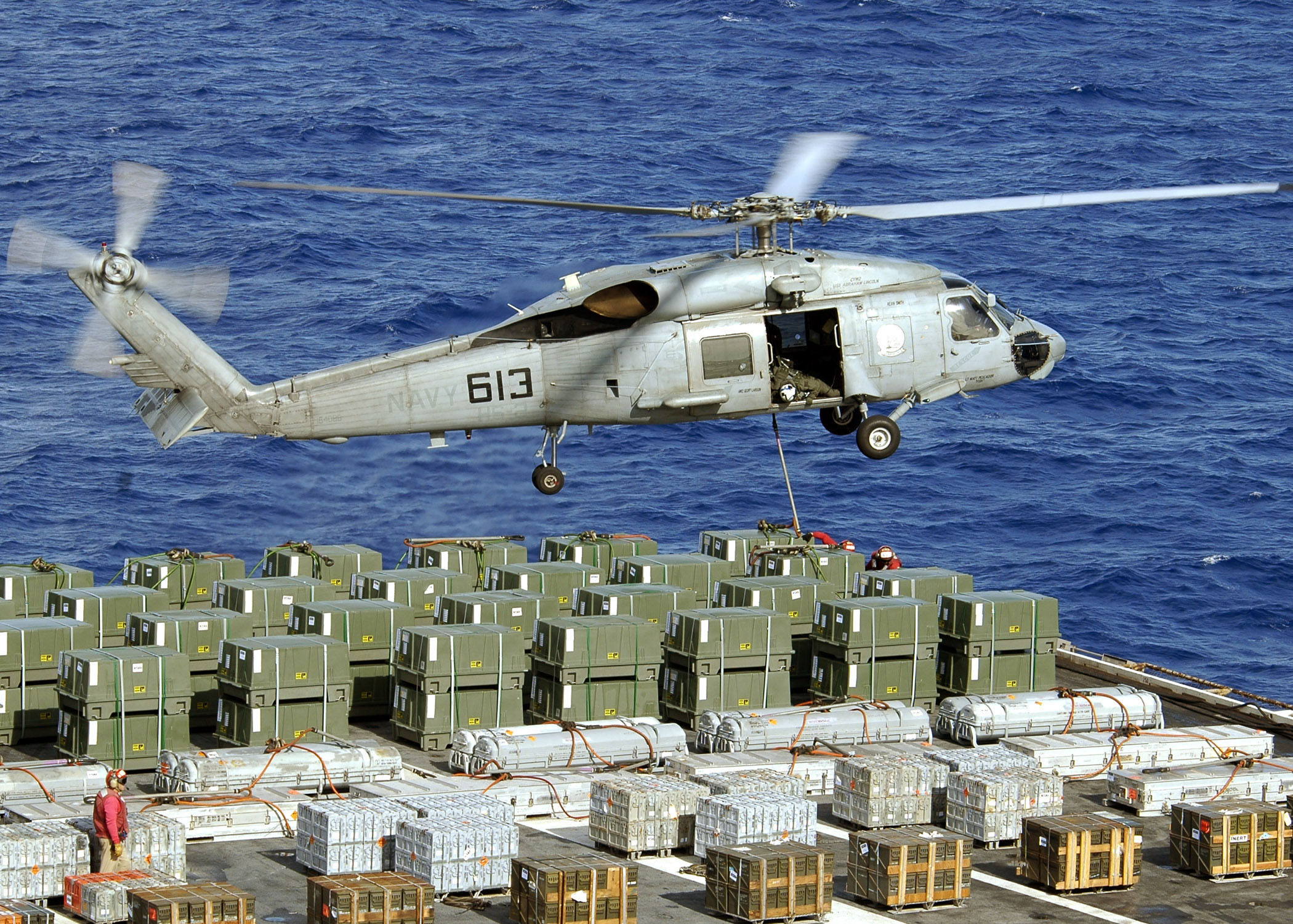 US Navy 060624-N-9898L-080 An SH-60 Seahawk assigned to the Golden Falcons of Helicopter Anti Submarine Squadron Two (HS-2) conducts a weapons offload from USS Abraham Lincoln (CVN 72)
