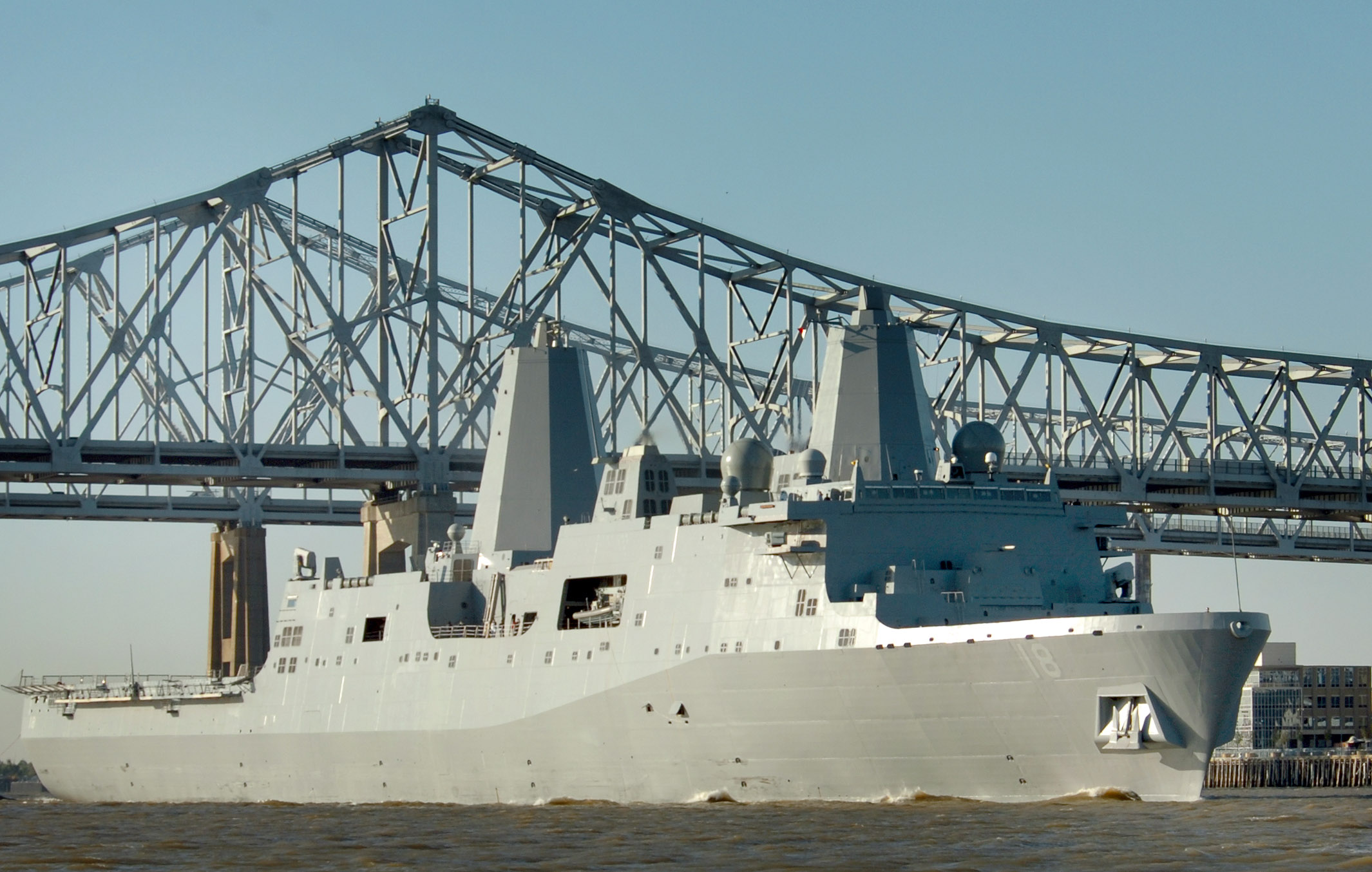 US Navy 061023-N-9995B-001 The Pre-Commissioning Unit New Orleans (LPD 18) transits past the city of New Orleans on the Mississippi River