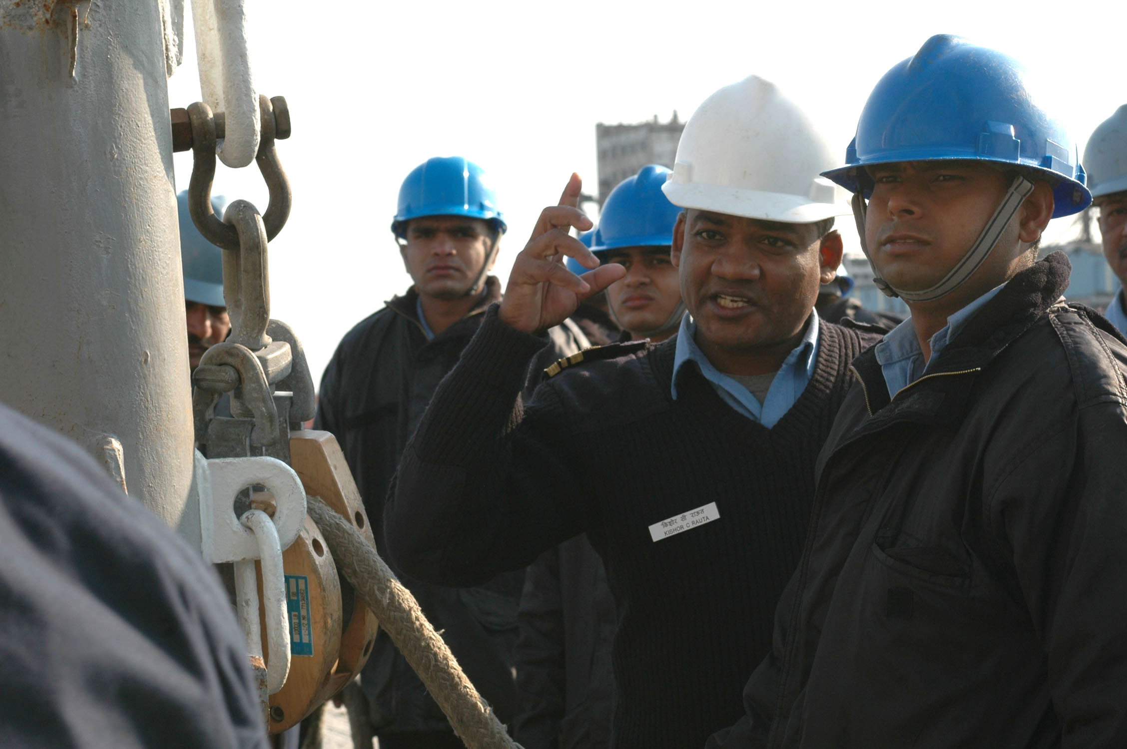 US Navy 061219-N-6410Z-474 An officer from the Indian navy instructs his junior sailors on how to properly rig a kingpost during a training exercise