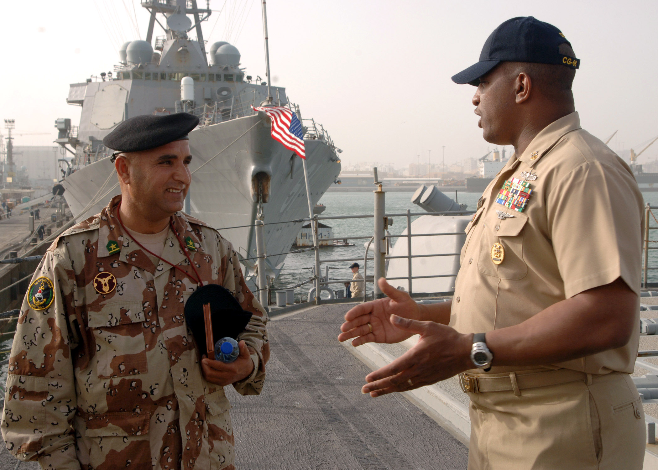 US Navy 070226-N-8560S-005 USS Anzio (CG 68) Command Master Chief William Seegars talks to Iraqi navy Chief Warrant Officer 2nd Class Abdul Majeed during a tour of the ship